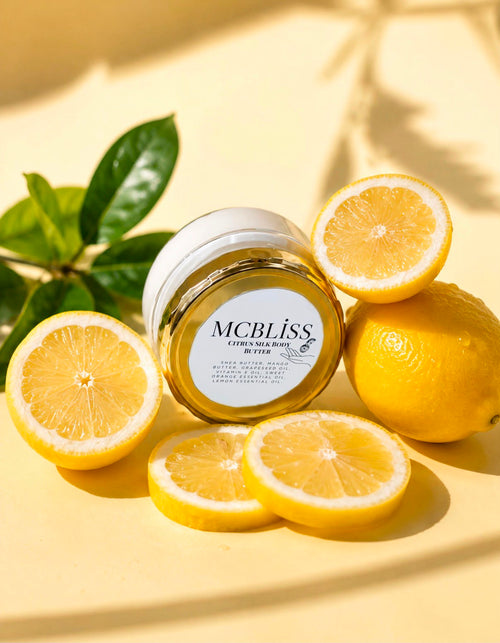 McBliss Citrus Silk Body Butter surrounded by fresh lemons